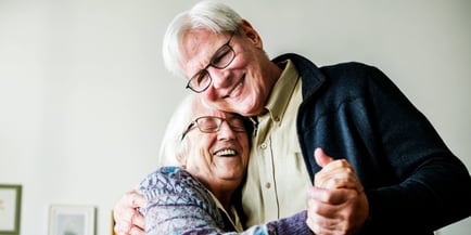 senior couple smiling and dancing