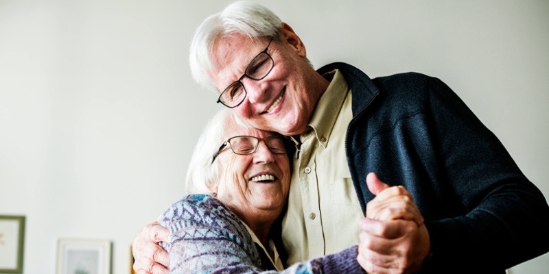 senior couple smiling and dancing