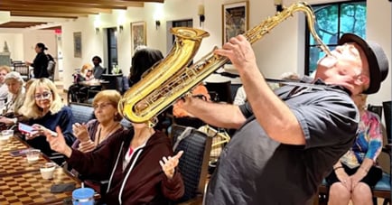 Man playing the trumpet durring happy hour