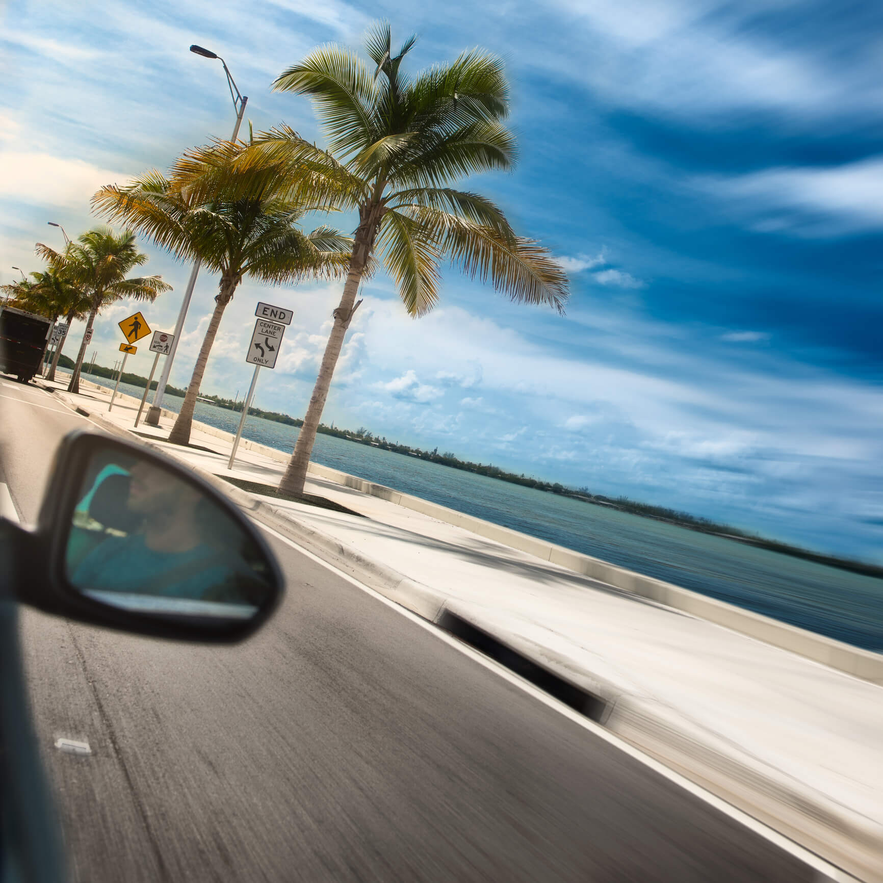 A scenic coastal drive lined with palm trees and ocean views, capturing the vibrant Florida lifestyle near senior living near beaches in FL.