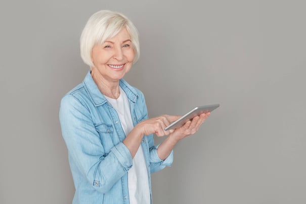 Senior holding an IPad