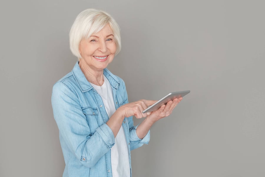 Senior holding an IPad