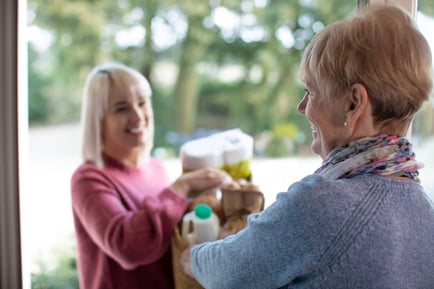 Resident and Caregiver bringing in groceries