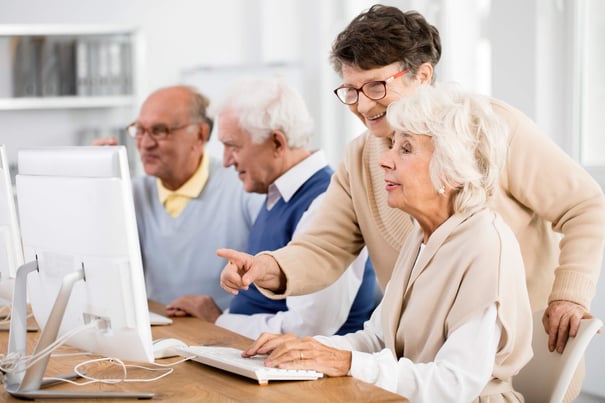 a group of seniors using computers