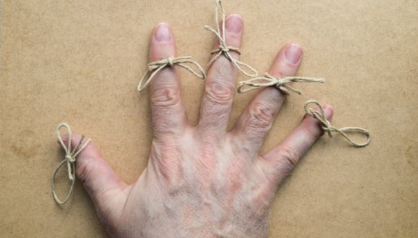 image of hand with bows tied on fingers
