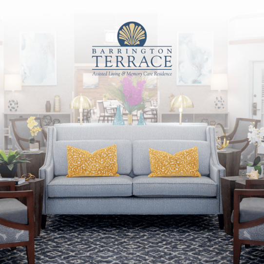 The Barrington Terrace digital brochure cover featuring a cozy sitting area with a gray sofa and gold accent pillows at this assisted living community in Fort Myers, FL.