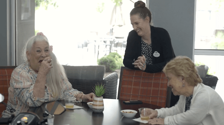 3 women talking at table
