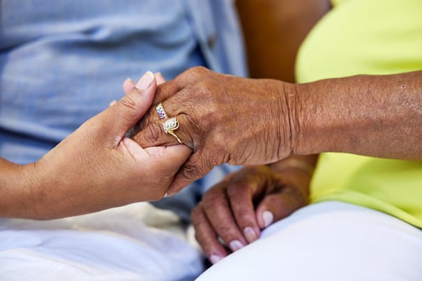 senior and daughter holding hands