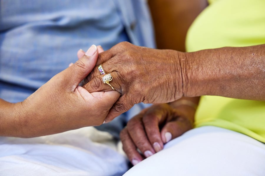 senior and daughter holding hands