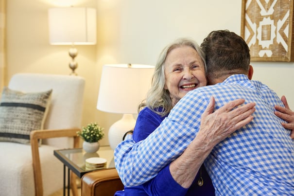 a senior lady hugging loved one