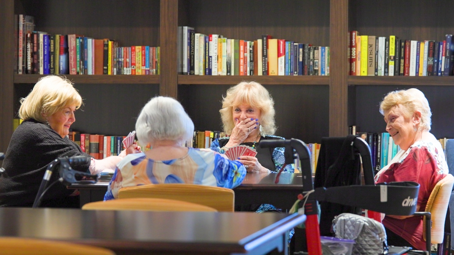 a group of senior ladies playing cards at the library
