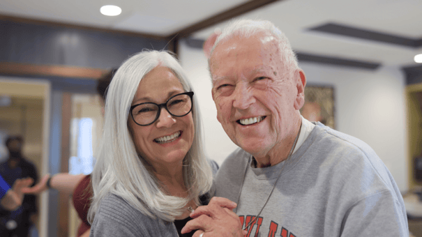 two seniors smiling while dancing