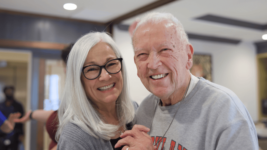 two seniors smiling while dancing