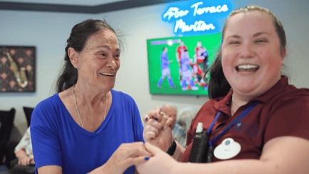 senior resident dancing with team member