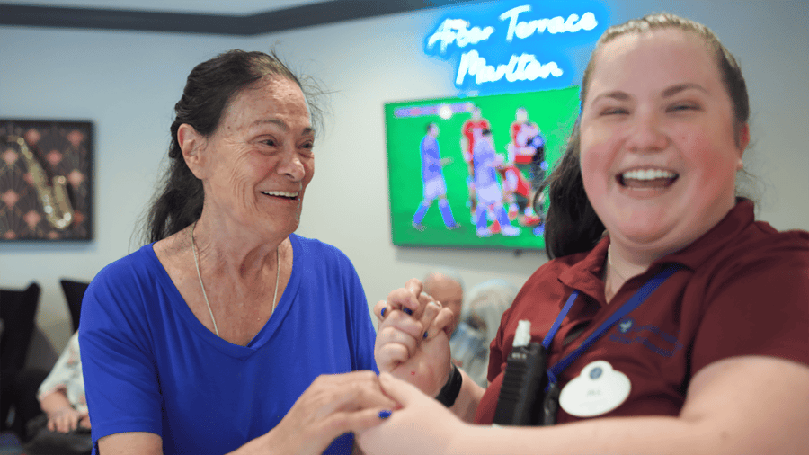 senior resident dancing with team member
