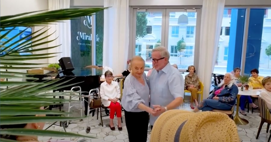 Residents dance and gather for a festive Havana Nights event at Mirabelle, a lively senior living community in Miami, FL where engaging social activities and themed celebrations bring people together.