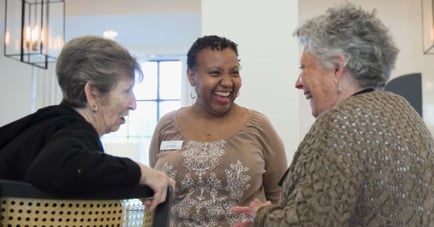two residents of Opus East Memphis laughing with a staff member