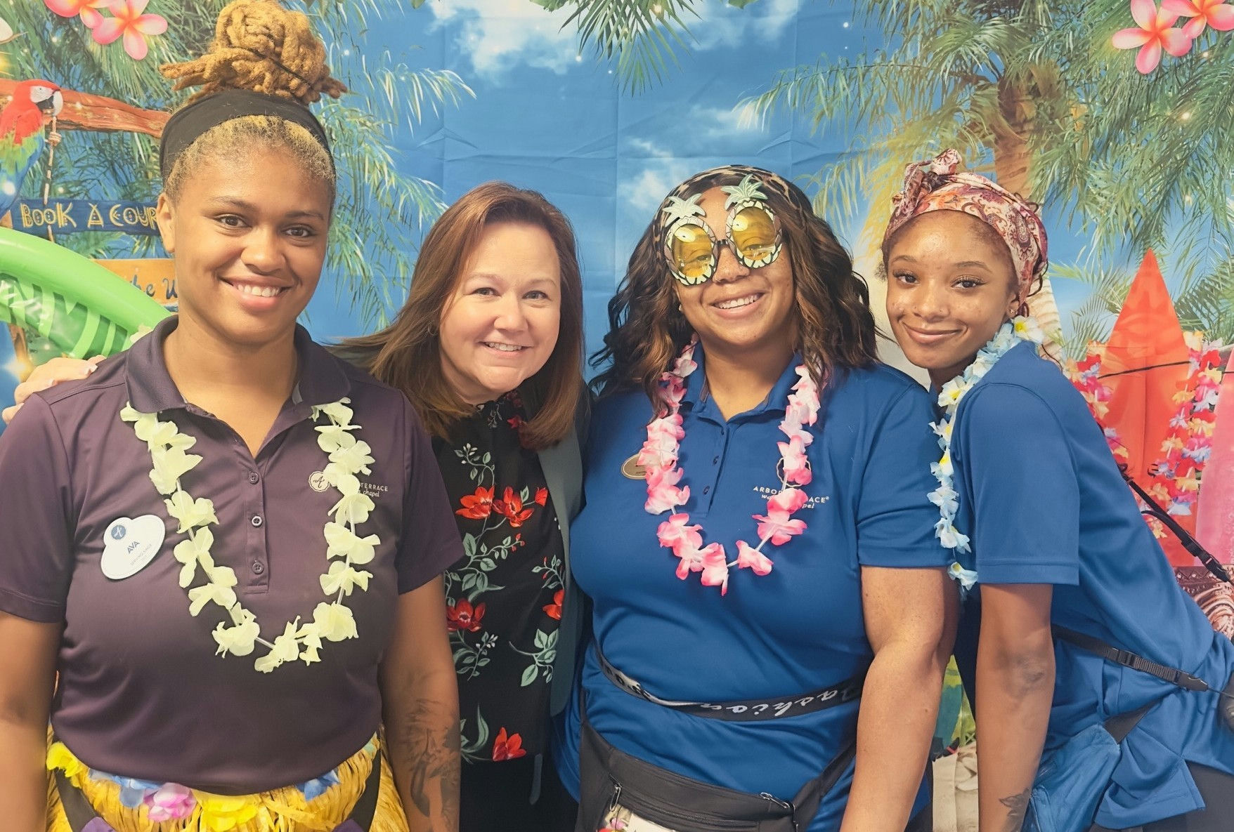 Arbor Terrace Waugh Chapel Staff Members Smiling at a Luau