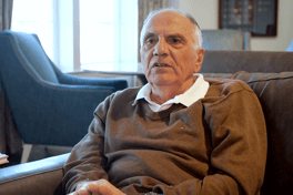 A senior man sitting on a sofa