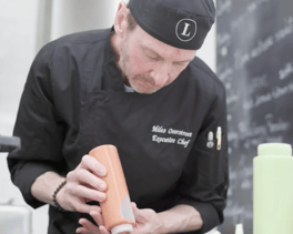 A chef doing plating a meal