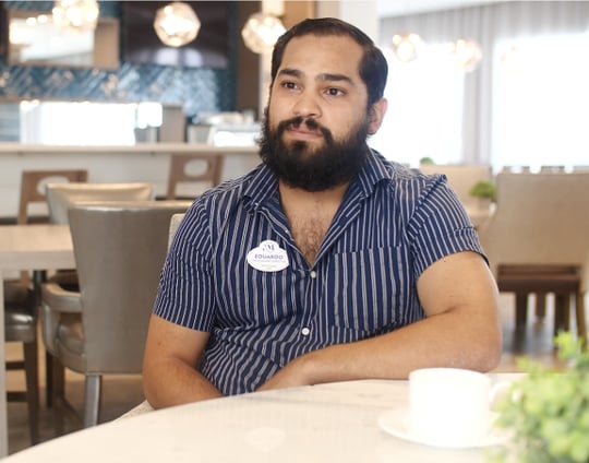 Eduardo, Mirabelle employee, sitting at table