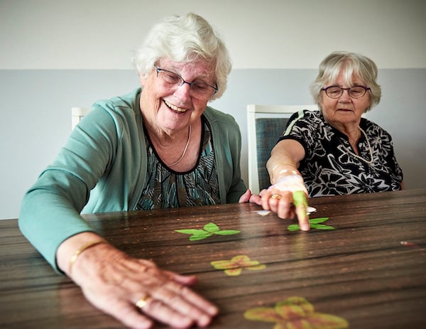 Female residents playing a game on Tovertafel