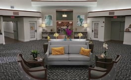 A welcoming common area with comfortable seating and warm lighting at this senior living community in Fort Myers, FL.