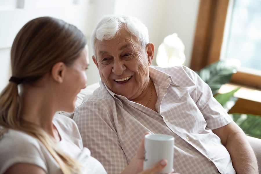 A senior man sharing a conversation with staff