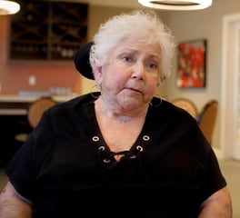 A staff member at Arbor Terrace Glenview senior living smiles warmly in the community space, reflecting the welcoming spirit of senior living in Glenview Illinois.