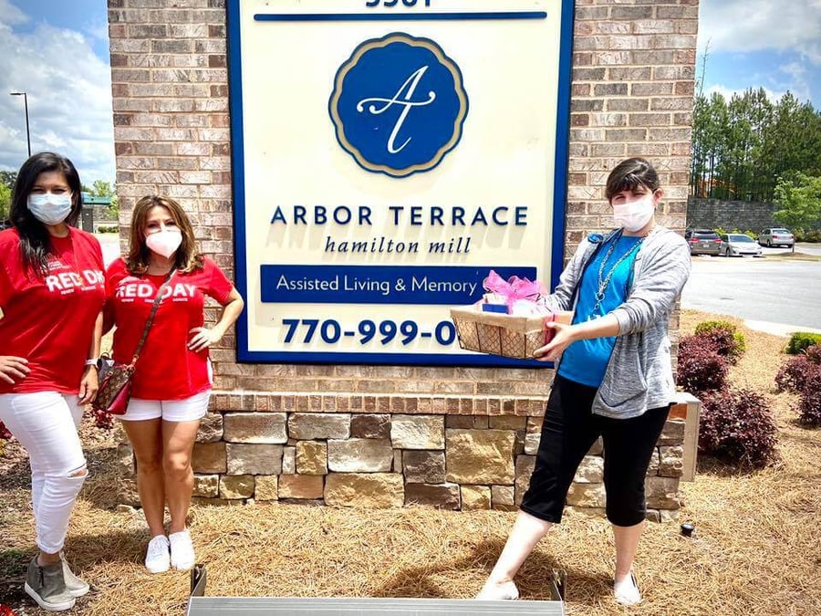 Arbor Terrace Hamilton Mill caregivers bringing gifts