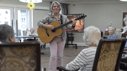 Arbor Terrace Hamilton Mill Residents listenting to the guitar