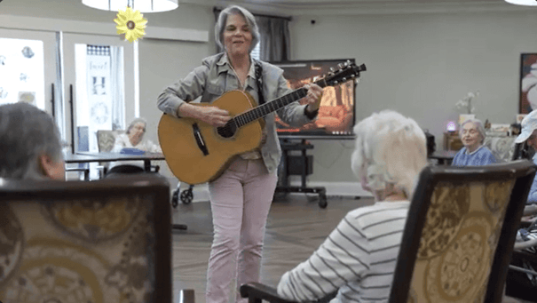 Arbor Terrace Hamilton Mill Residents listenting to the guitar