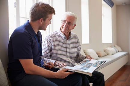 Exton resident and staff member looking at booklet