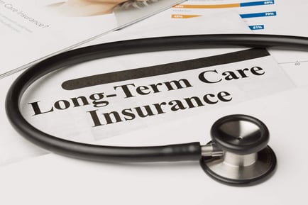 A stethoscope rests on a Long-Term Care Insurance document, illustrating helpful financial planning resources available to families exploring senior care options Fairfax County and independent living Herndon VA at Arbor Terrace Herndon.