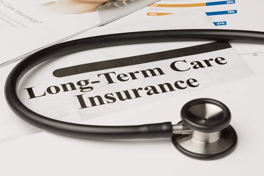 A stethoscope rests on a Long-Term Care Insurance document, illustrating helpful financial planning resources available to families exploring senior care options Fairfax County and independent living Herndon VA at Arbor Terrace Herndon.