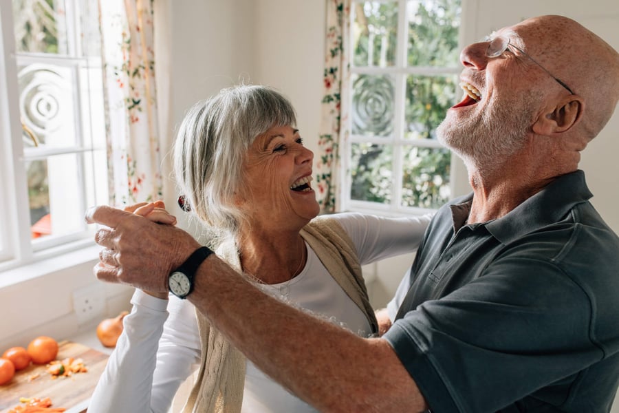 Senior couple smiling and dancing