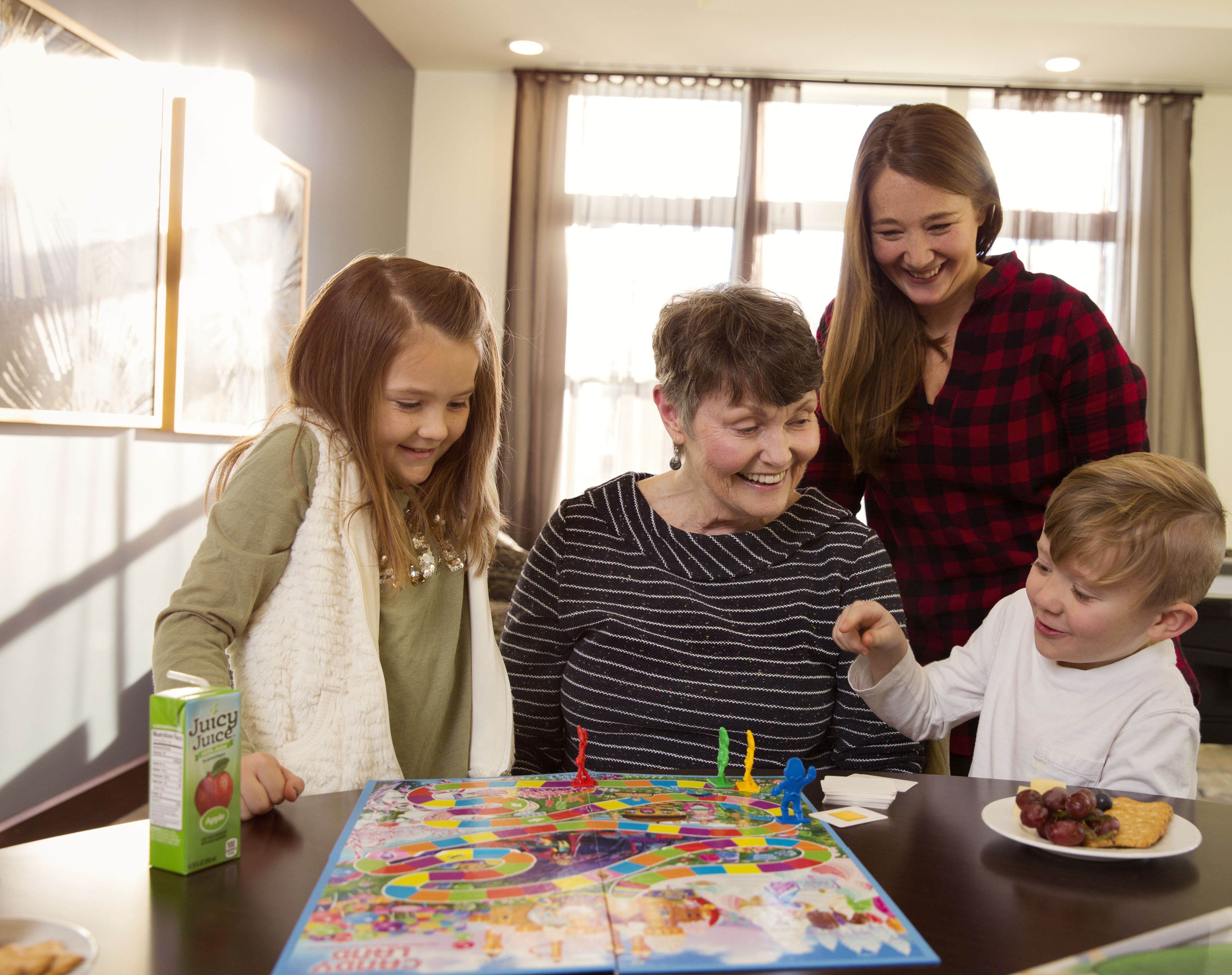 Arbor resident playing a board game with her family