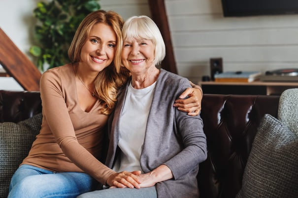a senior lady with her loved one hugging