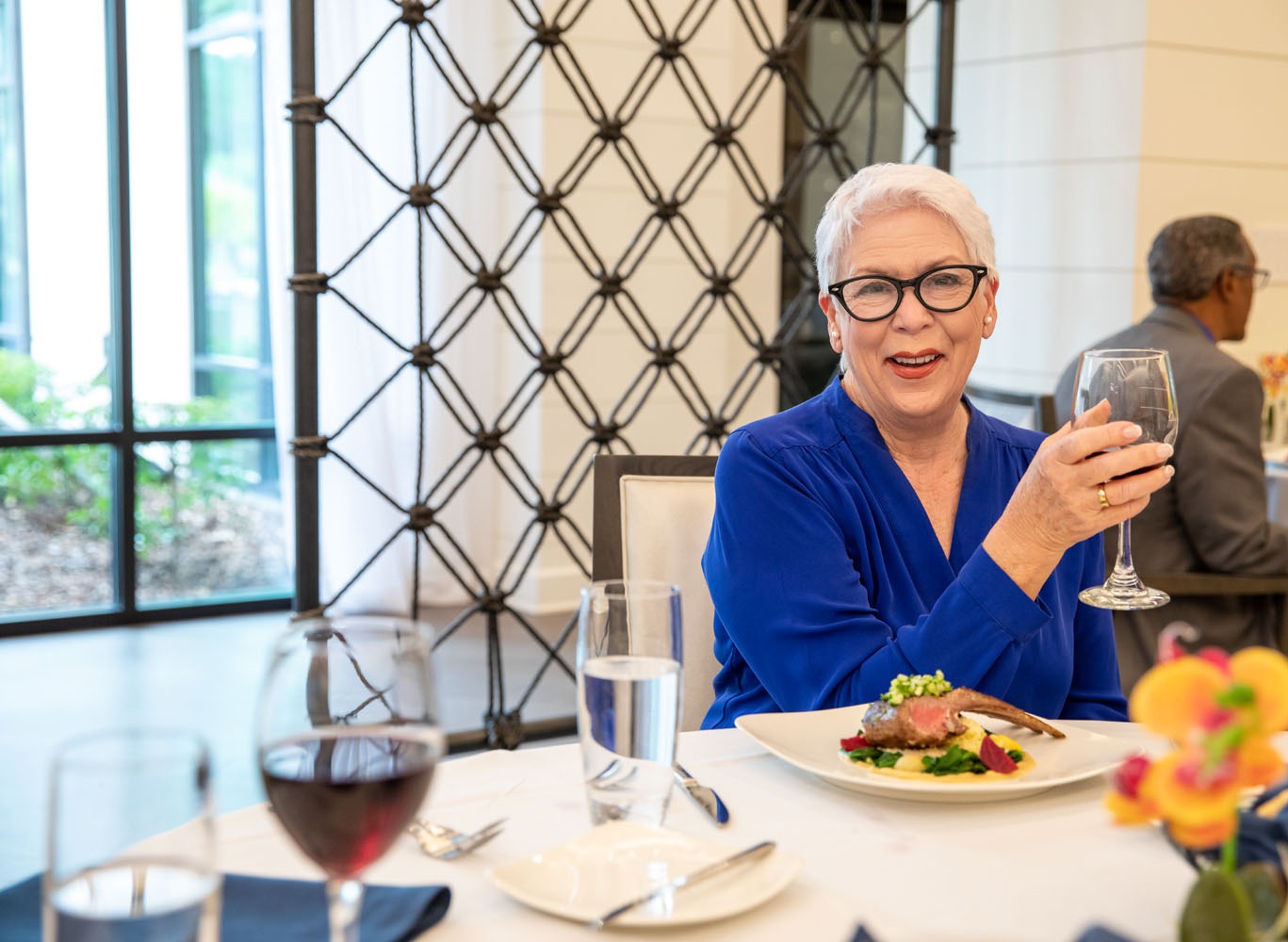 Senior woman enjoying a wine glass at Arbor