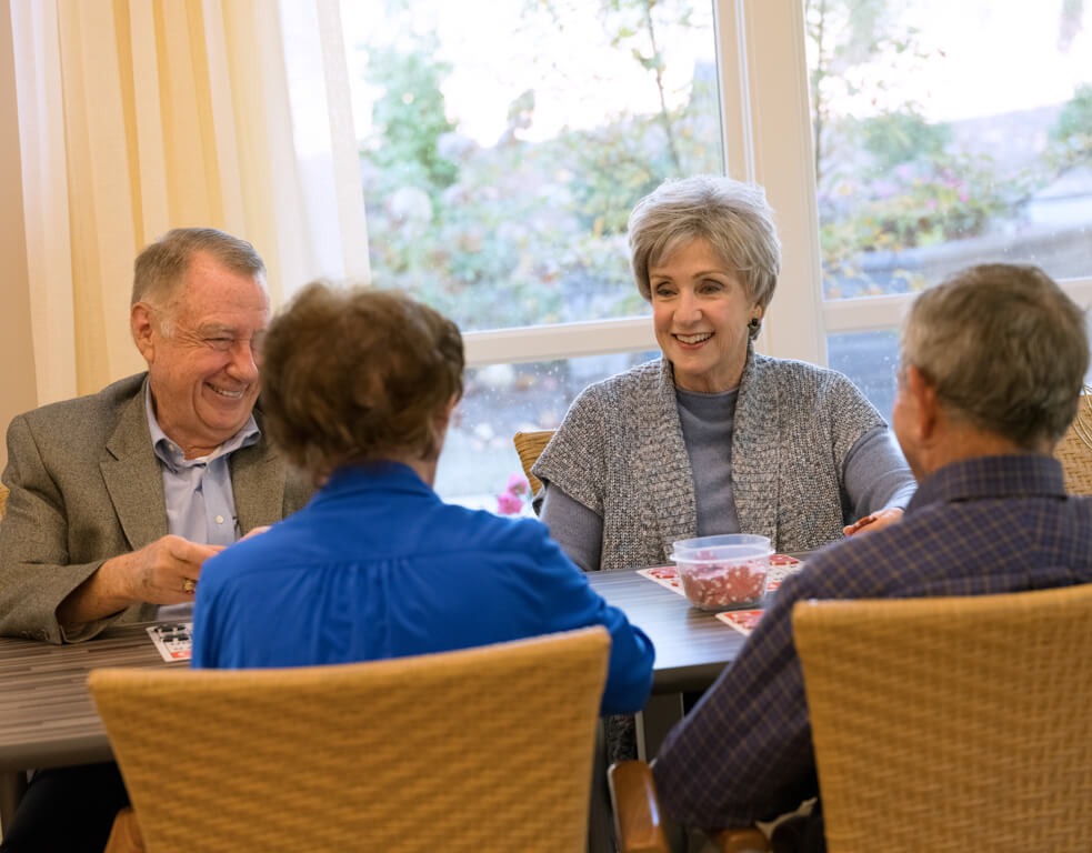 Seniors sharing stories at indoor restaurant at Arbor