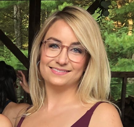 A lady with blonde hair and glasses