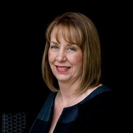 A professional headshot of a smiling woman against a dark background — the Executive Director leading the senior care team at Arbor Terrace Lakeway TX.