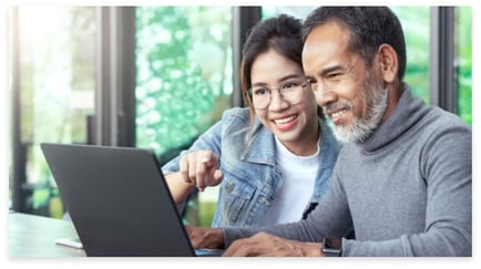 a senior resident and daughter using a laptop