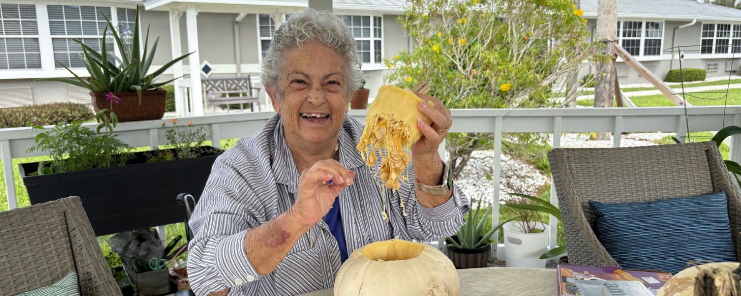 Texas - senior lady removing seeds from a pumpkin