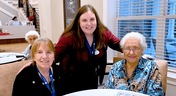 Arbor Terrace resident and staff smiling for a picture 