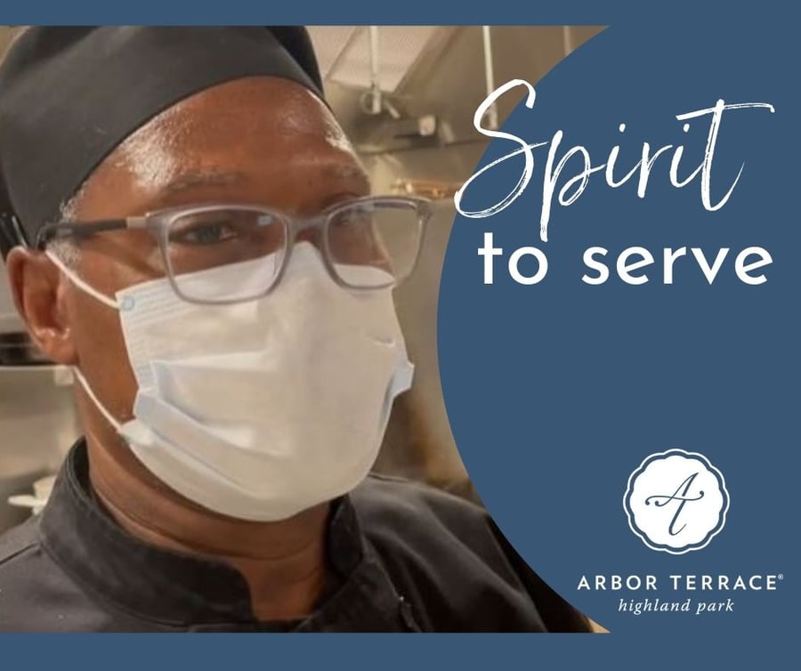 A kitchen staff member wearing a mask and glasses at Arbor Terrace Highland Park brings a spirit of service to daily meal prep, reflecting the caring senior living in Highland Park, IL, and the senior care Highland Park, Illinois, families trust.