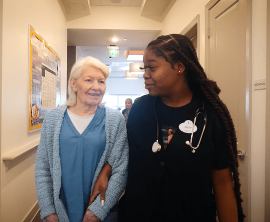 Mirabelle resident with nurse, smiling