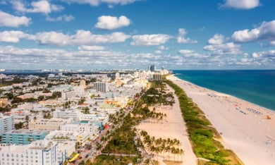 An aerial view of Coconut Grove's lush waterfront neighborhood, just a short drive from this senior living community in Miami, FL, offering bayfront parks, galleries, and a relaxed coastal atmosphere.