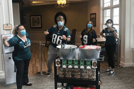 Staff member posing with Eagles jerseys on