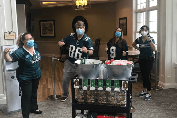 Staff member posing with Eagles jerseys on